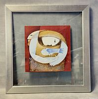 Framed abstract art print featuring stylized human figures and bird with red background, visible frame.