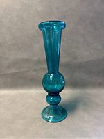 Front view of blue glass vase showing shape and color
