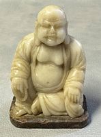 Front view of carved jade Buddha on base