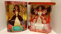 Two boxed Barbie dolls, Holiday Princess Belle and Holiday Joyous Fairy from Disney's Beauty and the Beast Holiday Special Edition, with note about included Barbie Doll Collecting Guide book.