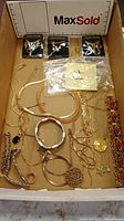 Overview of box contents showing all packaged and loose jewelry items