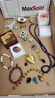 Full lot of vintage jewelry including necklaces, bracelets, pendants, and assorted brooches.