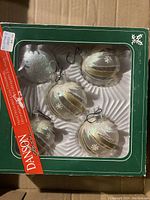 Five Danson Classic glass Christmas bulb ornaments in original green box with clear window showing ornaments inside arranged in molded plastic tray.