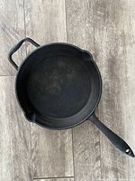 Top view of the 10-inch cast iron pan showing its cooking surface and two pouring spouts
