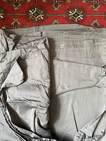 Light gray satin-like duvet cover spread out showing fabric texture and buttons for closure.