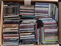 Photo showing the collection of music CDs neatly stacked inside a box. Visible titles include big band music, jazz, pop, and others.