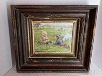 Front view of framed vintage print showing two children with animals in pasture, antique frame with some wear.