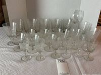 Set of 22 various sized etched crystal stemware glasses displayed on a white surface.