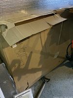 Closed cardboard box with handwritten 'Double Size' indicating bed size.