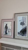 Two framed prints together showing black cat and iron sign artworks.