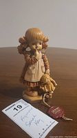 Front view of the Anri Sarah Key figurine showing girl holding doll