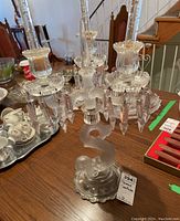 Full view of mermaid candelabra showing three arms, prisms, frosted mermaid base and one candle