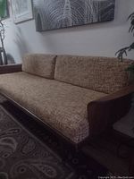 Front left view of couch with cushions installed showing overall appearance and fabric condition
