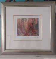 Framed 'Autumn's Garland' print by Tom Thomson, showing full frame and mat around print.