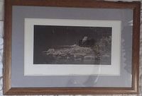 Full framed print showing wooden frame and gray mat with the natural scene of a heron on rocks.