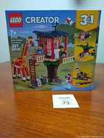 Front of unopened box showing LEGO Creator 3-in-1 Safari Wildlife Tree House set 31116 with giraffe and flamingo figures.