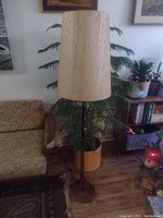 Full view of the teak floor lamp in a living room setting