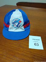 Front view of vintage baby Toronto Blue Jays baseball hat with team logo and red stripe on the blue and white panels.