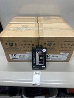 Four sealed overpack cartons (20 units each) with one retail packaged sample unit in front