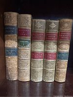 Six antique books arranged on a shelf showing spines with titles and volumes: British Poets Vol V, History of Rome Vol I, Motley’s Dutch Republic Volumes I, II, and III, and Chaucer's Poetical Works Vol I.