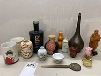 Wide shot showing entire collection of Asian decorative items on neutral background