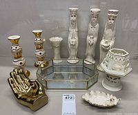 Full view of all decorative items showing Three Wise Men figurines, candlesticks, mirrored tray, leaf dish, gold hand sculpture, and lidded holder.