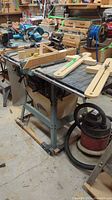 Full view of Delta XL-10 table saw on wheeled stand with fence and dust bag