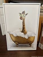 Front view of the framed pop-art print showing giraffe in bathtub with bubbles and goggles.