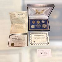 Photo of 1944 Year to Remember coin set in hardcase with six coins and three accompanying documents including certificate of authenticity and historical info.