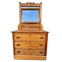 Front view of wooden dresser with three drawers and attached mirror showing overall condition and detailing.