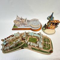 Photo showing three scale models: Vatican, Windsor Castle, and a puppet theater scene grouped together on a flat surface.