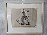 Full front view of framed charcoal drawing behind glass