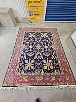 Full view of rectangular oriental-style rug with white fringe on one end