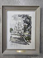 Framed original watercolor painting of Sacré-Cœur Basilica in Paris with visible artwork and frame.