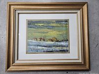 Full view of the framed landscape painting depicting houses in winter, showing the frame, matting, and artwork.