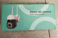 Original packaging box showing image and model of Dome HD camera for smart home security.