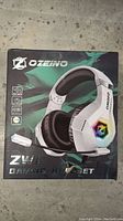 Front box image of Ozeino ZW1 gaming headset showing brand, model, and headset visual on the packaging.