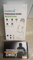 Box of ZealSound Professional Studio Microphone with key features listed and box of Professional Audio Series headphones or related product.
