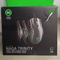 Front of original packaging for Razer Naga Trinity wired gaming mouse showing images of the mouse and three interchangeable side plates.