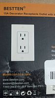 Photo of BESTTEN brand packaging showing 15 amp decorator receptacle outlet with model number USP 15-B-20PK and contact information.
