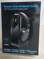 Box showing the product image and key features of the wireless stereo headphone system including 2.4GHz wireless technology, zero latency, and multiple connectivity options.