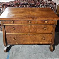 Front view of antique wooden dresser showing drawer arrangement and natural wood finish.