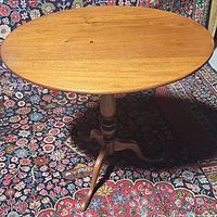 Full view of the oval top showing wood grain and surface wear.