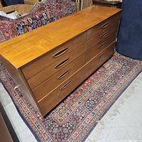 Front angle view of entire dresser showing wood veneer finish and overall shape
