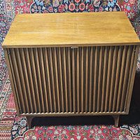 Front view of brown fluted cabinet on bracket base