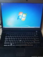 Dell Latitude E6410 laptop powered on, showing Windows 7 desktop screen