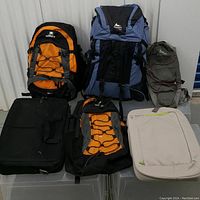 Front view of all six items on clear bins against a metal door