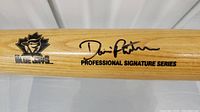 Close-up photo of the baseball bat showing the Blue Jays logo and Dave Righetti's black signature with 'Professional Signature Series' printed.