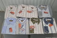 Top view of all shirts mostly packaged, showing patterns of stripes and polka dots in various colors.