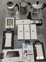 Photo showing two Bialetti coffee makers, ceramic salt and pepper shakers, Sojos glasses boxes, Pelican iPhone X cases.